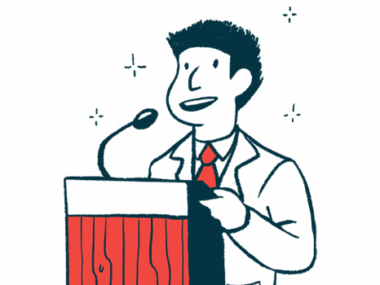 A man speaks from a podium using a microphone.