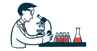 A scientist looks into a microscope.
