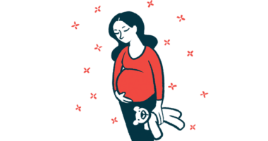 A pregnant woman cradles her belly.