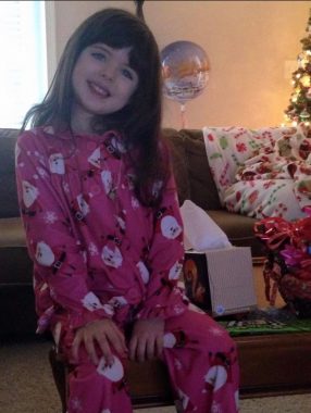 Christmas in the hospital | Pulmonary Hypertension News | Riley Wiegele, is shown at home in her pajamas, smiling, after spending Christmas 2014 in the hospital