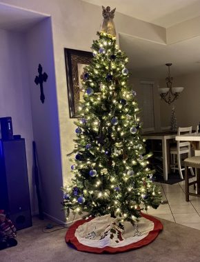 holidays with PH | Pulmonary Hypertension News | A Christmas tree decorated with lights and an angel on top glows at night in the Cueva home.
