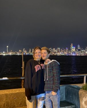 PH siblings | Pulmonary Hypertension News | Collen's son Aidan, soon to be 21, poses with his girlfriend, Sally, in front of the nighttime skyline of Seattle.