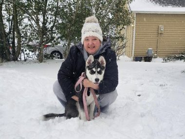 pets and caregivers | Pulmonary Hypertension News | Colleen hugs Harmony, the husky, on a snowy and cold day in February 2021.