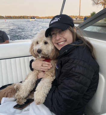 dog | Pulmonary Hypertension News | Anna holds her dog, Luna, while sitting in her family's boat.