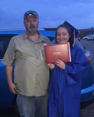 transplant | Pulmonary Hypertension News | Dressed in a high school graduation gown and cap, Rebekah shows her diploma while posing with her dad.