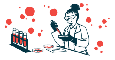 A scientist works with petri dishes in a lab along side a rack of vials filled with blood.