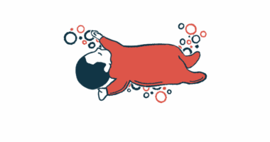 An infant lies on her back, napping.