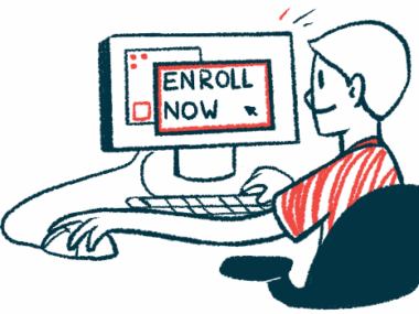 A person sits with one hand on a computer mouse in front of a monitor showing the words 