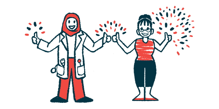 A clinician in a white lab coat with a red head scarf stands next to a person with a red shirt and black pants, both making the thumbs up gesture, with fireworks in the background.